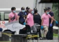 Security personnel outside a school in Tacloban City after a shooting incident in the Philippines.
