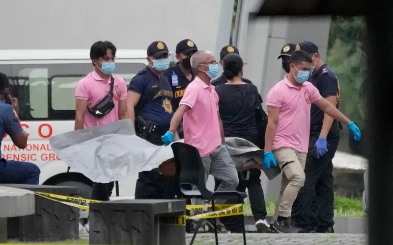 Security personnel outside a school in Tacloban City after a shooting incident in the Philippines.