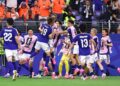 Japan celebrate their late equaliser against the Netherlands in a World Cup Group F match.
