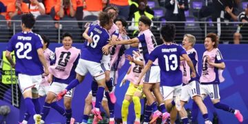 Japan celebrate their late equaliser against the Netherlands in a World Cup Group F match.