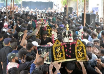 Youm-e-Ashura mourning procession with security personnel deployed along the route in Pakistan