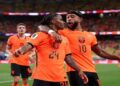 Netherlands players celebrating a goal against Sweden during a World Cup Group F match.