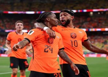 Netherlands players celebrating a goal against Sweden during a World Cup Group F match.