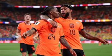Netherlands players celebrating a goal against Sweden during a World Cup Group F match.