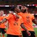 Netherlands players celebrating a goal against Sweden during a World Cup Group F match.