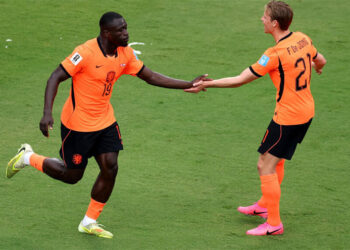 Netherlands football team celebrating a goal during their 3-1 FIFA World Cup victory over Tunisia
