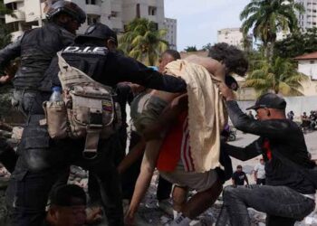 Rescue workers clearing earthquake rubble in Caracas after powerful twin earthquakes in Venezuela
