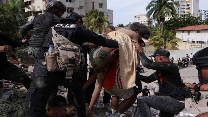 Rescue workers clearing earthquake rubble in Caracas after powerful twin earthquakes in Venezuela