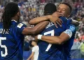 Kylian Mbappe celebrating a goal for France during a World Cup match delayed by storm at Lincoln Financial Field