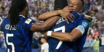 Kylian Mbappe celebrating a goal for France during a World Cup match delayed by storm at Lincoln Financial Field