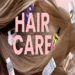 Healthy hair protected from sun exposure with summer hair care products and a wide-brim hat