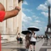People walking in Paris under intense sunlight during a severe Europe heatwave