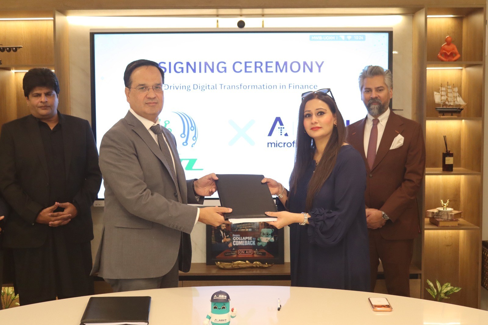 ABHI Microfinance Bank and NADRA Technologies officials signing agreement to promote digital financial services in Pakistan.