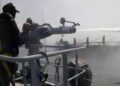 Naval firefighting operation controlling fire on merchant vessel MT Shalamar in the Arabian Sea near Gwadar.