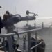 Naval firefighting operation controlling fire on merchant vessel MT Shalamar in the Arabian Sea near Gwadar.