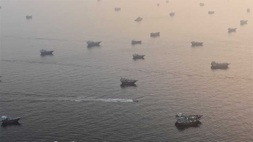 Large crude oil tankers sailing through the Strait of Hormuz carrying Middle Eastern energy exports.