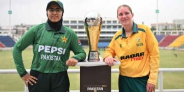 Pakistan U-19 and South Africa U-19 women's cricket captains pose with the T20 series trophy before the opening match in Karachi.