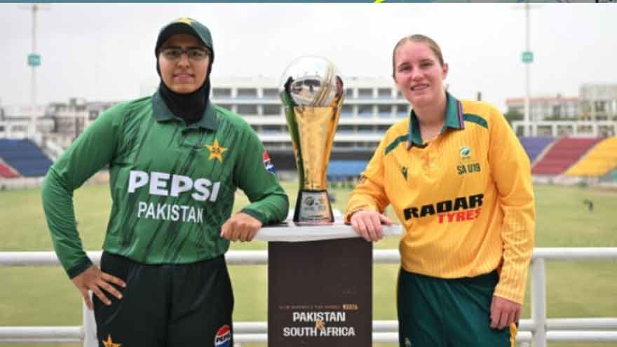 Pakistan U-19 and South Africa U-19 women's cricket captains pose with the T20 series trophy before the opening match in Karachi.