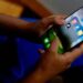 A smartphone displaying social media apps alongside Australia's online safety regulations.