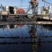 Oil barrels representing Brent crude and WTI prices amid Middle East geopolitical tensions.