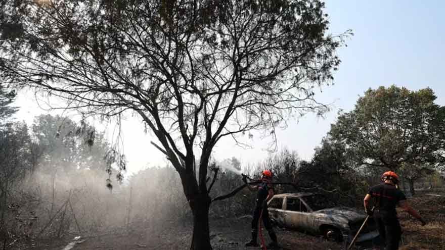 Firefighters responding to a large wildfire in Spain during extreme summer heat.