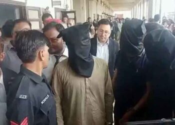 Karachi police officers secure an area during an SIU operation related to the Dr Akash murder case.