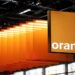 Orange logo displayed with modern data centre infrastructure representing the planned AI and cloud computing expansion in France.