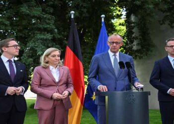 German Chancellor Friedrich Merz speaks during a political event as his government faces criticism over a cabinet reshuffle.