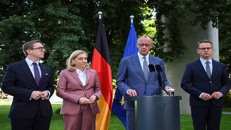 German Chancellor Friedrich Merz speaks during a political event as his government faces criticism over a cabinet reshuffle.