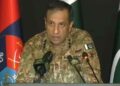 DG ISPR Lieutenant General Ahmed Sharif Chaudhry prepares to brief the media on Pakistan's security situation and counterterrorism operations.