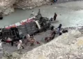 Emergency responders conduct rescue operations at the site of a deadly passenger coach crash in Balochistan's Dana Sar area.