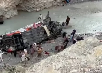 Emergency responders conduct rescue operations at the site of a deadly passenger coach crash in Balochistan's Dana Sar area.