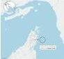 Commercial ships transit the Strait of Hormuz amid heightened military tensions between the United States and Iran