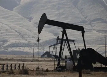 Oil storage tanks and tanker ships representing global crude markets as Brent and WTI prices edge higher.