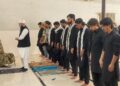 Participants from Shia and Sunni communities offer Zuhrain prayers together during the Youm-e-Hussain event at Federal Urdu University in Karachi.