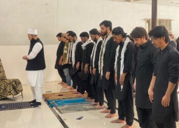 Participants from Shia and Sunni communities offer Zuhrain prayers together during the Youm-e-Hussain event at Federal Urdu University in Karachi.