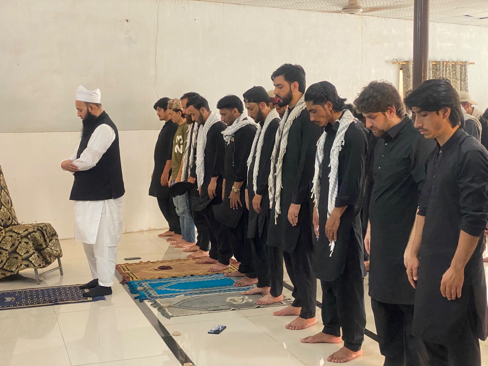 Participants from Shia and Sunni communities offer Zuhrain prayers together during the Youm-e-Hussain event at Federal Urdu University in Karachi.