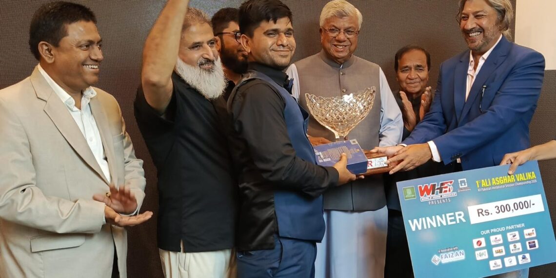 Rana Irfan receives the winner's trophy after claiming the Ali Asghar Valika All-Pakistan Snooker Championship in Karachi.