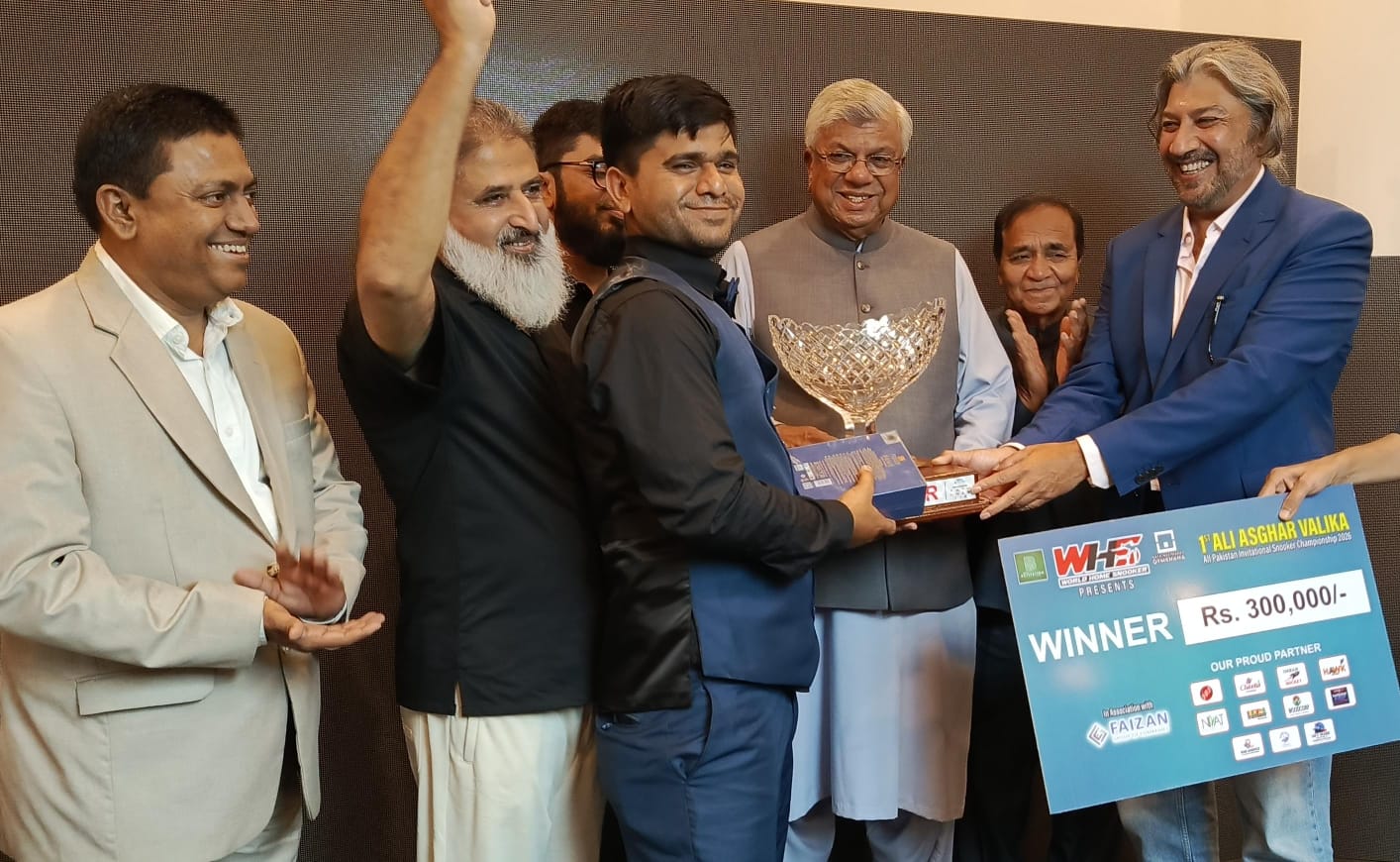 Rana Irfan receives the winner's trophy after claiming the Ali Asghar Valika All-Pakistan Snooker Championship in Karachi.
