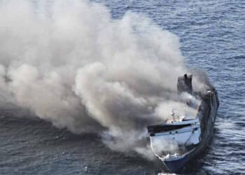 Rescue vessels assist passengers after a ferry caught fire at sea in Indonesia.