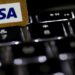 Visa logo alongside cybersecurity graphics representing its acquisition of fraud intelligence company BioCatch.