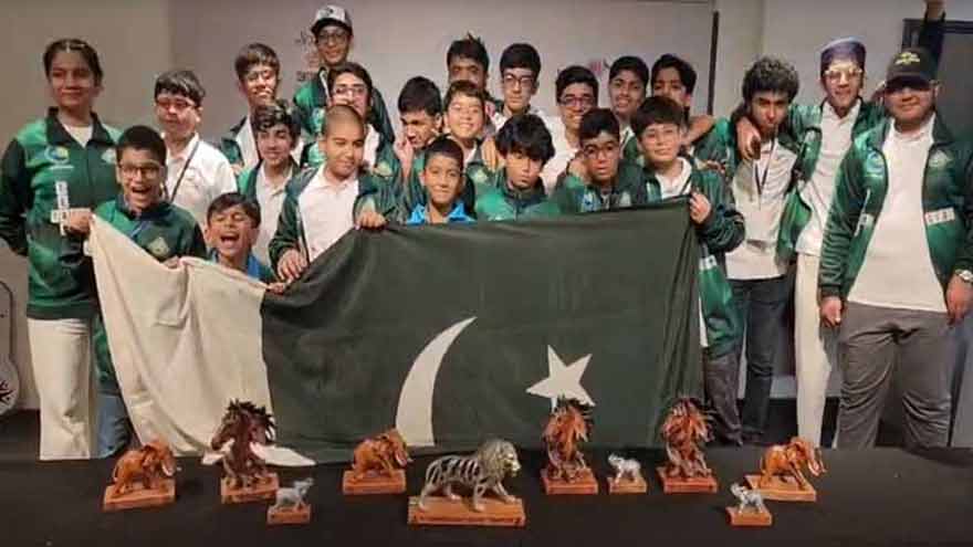 Pakistani young Scrabble players celebrate winning the world team title