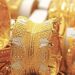Gold bars and market price board showing rising gold prices in Pakistan