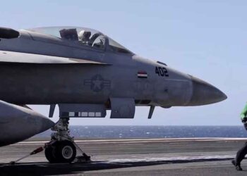 US Navy aircraft carrier during operations as Trump orders changes to shipbuilding policy.