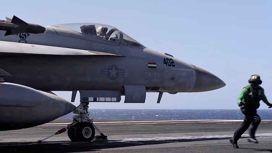 US Navy aircraft carrier during operations as Trump orders changes to shipbuilding policy.