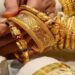Gold bars and coins representing falling gold prices in Pakistan and international markets.