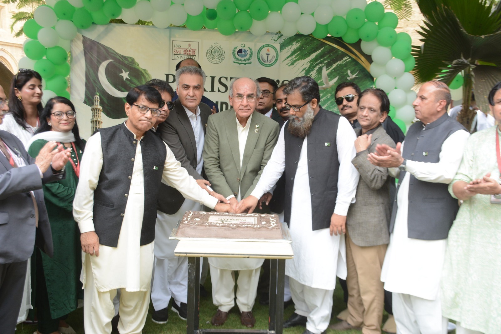 SMIU Vice Chancellor Dr Mujeeb Sahrai hoists the Pakistani flag during Independence Day celebrations in Karachi.