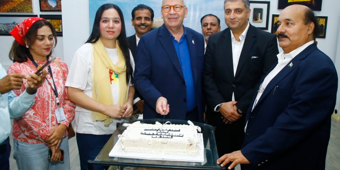 Photographers and artists attend a World Photography Day exhibition at the French Cultural Centre in Karachi