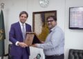 Mobiz’s Head of Data, Dr. Akbar Gardizi, is presenting a shield to Dr. Kabir Sidhu, Chairman SECP.