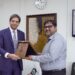 Mobiz’s Head of Data, Dr. Akbar Gardizi, is presenting a shield to Dr. Kabir Sidhu, Chairman SECP.